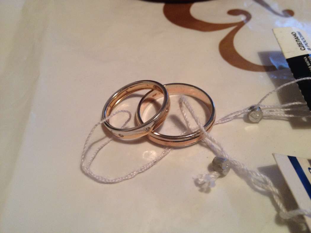 Золотые кольца выполненные в классическом стиле на фоне кремовой поверхности - фото 2715505 Невеста01